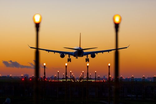 airplane landing at sunset