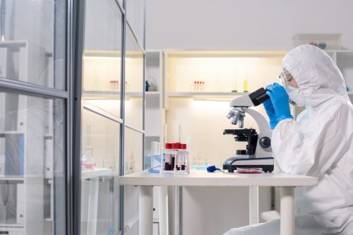 Scientist in lab wearing safety gear