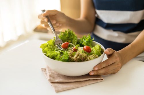 young woman buying salad