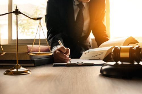 A lawyer signing papers on his desk