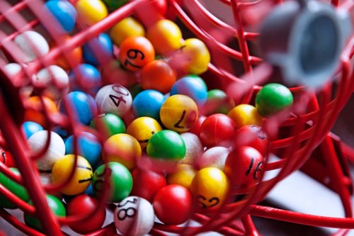 Lottery drawing with different colored balls with numbers.