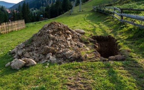 Digged grave in the backyard in mountains