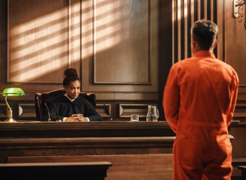 Law Offender in Orange Jumpsuit is Questioned and Giving Testimony to Judge, Jury