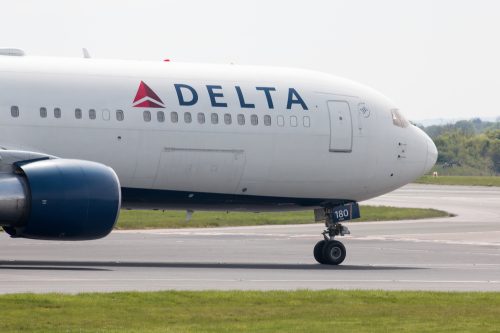 A Delta Air Lines jet taxiing on the runway at an airport