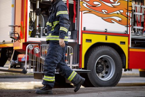 Bikini-Clad Woman in High Heels Exits Fire Truck and Enters Strip Club