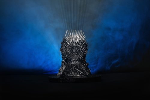 The model of throne as in Game of throne at a bright blue smoked background