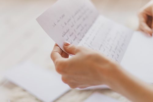 Hands of young woman holding handwritten letter