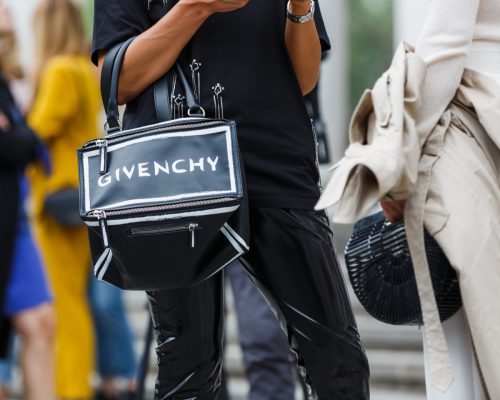 Woman holding Givenchy bag.