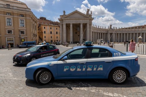 Cars of the Carabinieri service and the police service on St. Peter's Square in front of St. Peter's Cathedral in the Vatican.