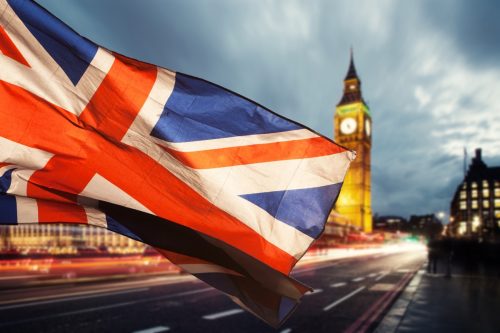 Union jack flag and iconic Big Ben at the palace of Westminster, London.