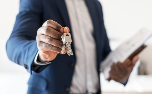 Real estate agent handing the house key