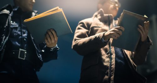 Policeman is reviewing files and documents