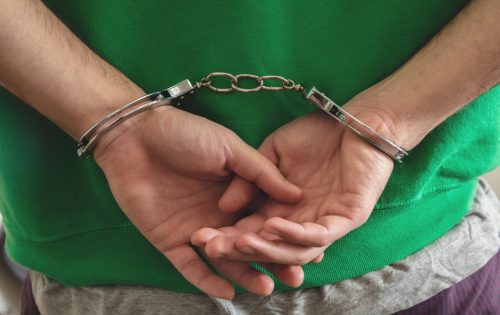 Arrest, Handcuffed criminal man hands close up