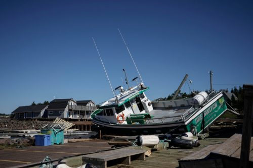 Damage to the Stanley Bridge Marina, including a boat knocked ashore from wind and storm surge, a day after Post-Tropical Storm Fiona hit the Atlantic coast n September 25, 2022 in New London, Prince Edward Island, Canada
