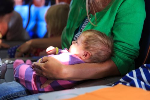 Mother and infant daughter travel by plane.