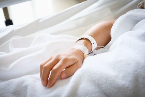 Patient sleeping in hospital bed.