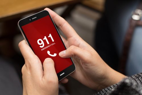 Hands on phone calling 911.