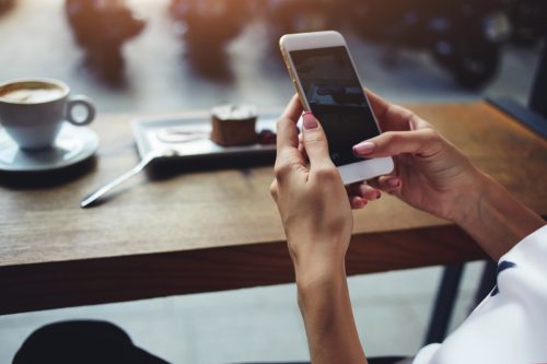 Woman Holding Up Cell Phone