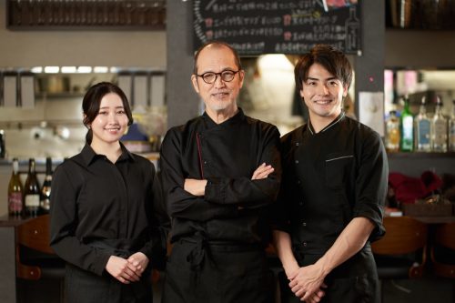 Asian chefs working in restaurant.