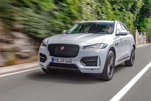 Jaguar F-Pace fast on a country road. 