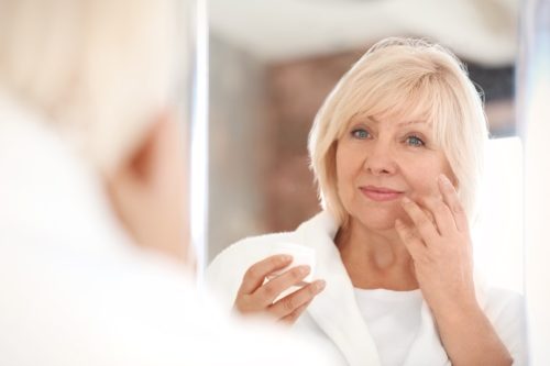 woman doing face exercises