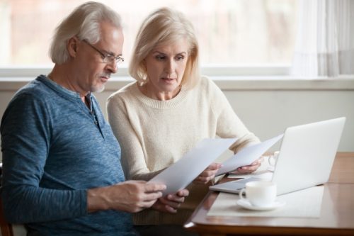 older couple going over financial documents, empty nest