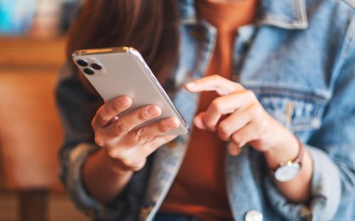 A woman using an iPhone