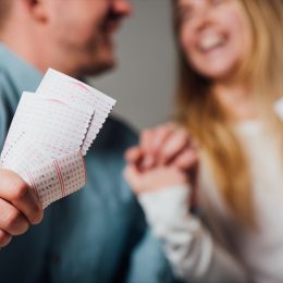 Couple holding lottery tickets
