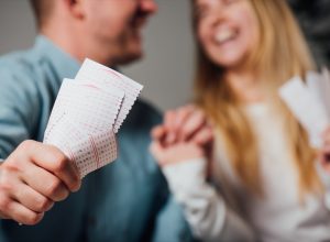 Couple holding lottery tickets