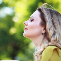 Woman with blond hair in summer park