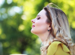 Woman with blond hair in summer park