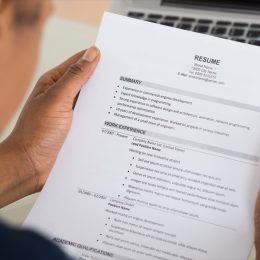 Close-up Photo Of A Businesswoman Holding Resume