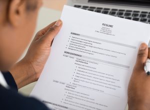 Close-up Photo Of A Businesswoman Holding Resume