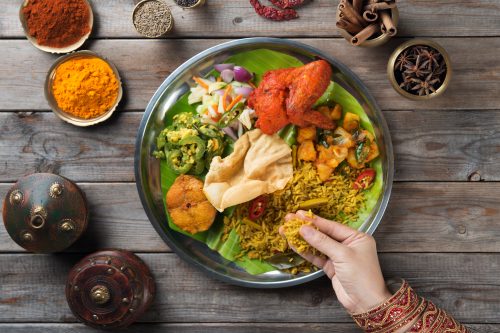 Woman eating food using her hands.