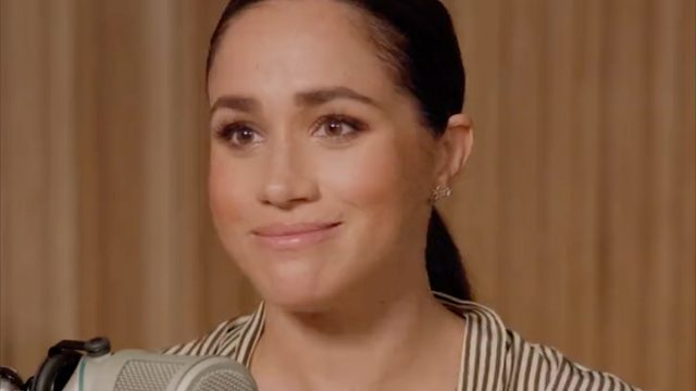 Meghan Markle speaking to a microphone.