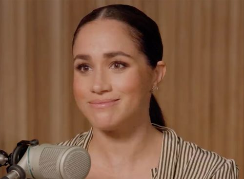 Meghan Markle speaking to a microphone.