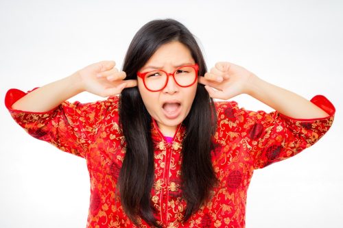 woman annoyed by loud sound