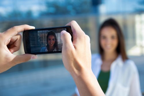 couple taking photos with mobile.