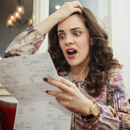 Woman shocked and surprised with her electricity bills
