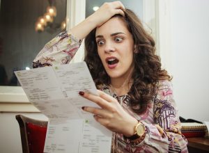 Woman shocked and surprised with her electricity bills