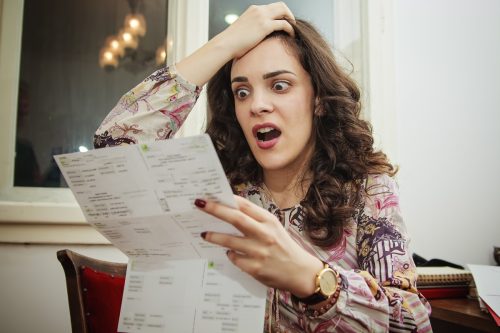 Woman shocked and surprised with her electricity bills
