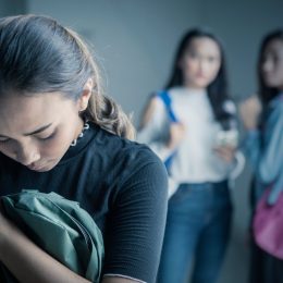 Teenage girl bullied by her colleagues in the classroom.