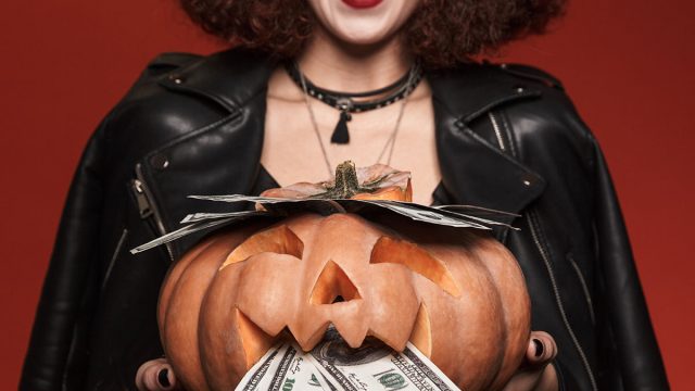 Image,Of,Cute,Witch,Girl,In,Halloween,Costume,Holding,Carved