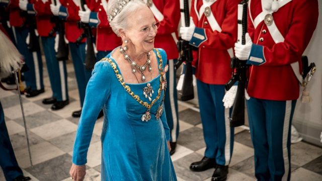 Queen Margrethe of Denmark reviews an honour guard as she arrives to the gala banquet at Christiansborg Palace