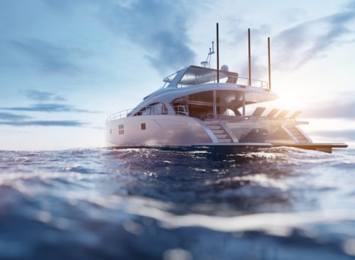 Luxury motor yacht on the ocean at sunset.