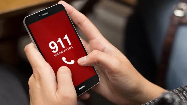 Hands on phone calling 911.