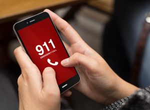 Hands on phone calling 911.