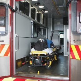 Paramedic's truck with open back doors, where stretcher and medical equipment is visible.