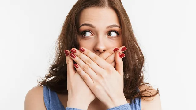 Portrait,Of,A,Surprised,Young,Woman,Covering,Mouth,With,Hands