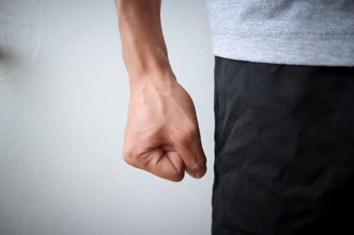 Flea angry man wearing a gray shirt and black pants emotionally angry anger of asian people and blood vessels at hand and white background texture objects